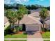 Inviting single-story home featuring a two-car garage, paver driveway, mature palm trees, and manicured landscaping at 1233 Girog Ave, Port Orange, FL 32129