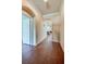 Bright hallway featuring tile flooring, neutral walls, an arched doorway, and views into the living space at 1233 Girog Ave, Port Orange, FL 32129