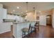 Eat-in kitchen featuring counter seating, granite counters, stainless steel sink, and modern pendant lights at 1233 Girog Ave, Port Orange, FL 32129
