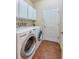 Convenient laundry room with washer, dryer, and storage cabinets, designed for efficient chores at 1233 Girog Ave, Port Orange, FL 32129