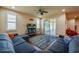 Comfortable living room with sectional sofa, ceiling fan, and sliding glass doors to screened porch at 1233 Girog Ave, Port Orange, FL 32129