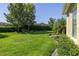 Expansive backyard featuring lush lawn, mature trees, and a well-maintained garden bed along the property line at 1386 Brayford Pt, Deland, FL 32724