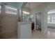 Well-lit bathroom boasts tiled walk-in shower, double vanities, and a separate toilet room at 1386 Brayford Pt, Deland, FL 32724