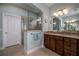 This light and airy bathroom features a walk-in shower with glass door, and double vanities at 1386 Brayford Pt, Deland, FL 32724