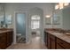 Bright bathroom featuring double vanities, granite countertops, and an arched doorway to the main bedroom at 1386 Brayford Pt, Deland, FL 32724