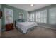This airy bedroom features plantation shutters, comfortable bedding, and soothing color palette at 1386 Brayford Pt, Deland, FL 32724