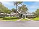 Charming community center featuring a covered entrance, manicured landscaping, and ample parking on a bright day at 1386 Brayford Pt, Deland, FL 32724