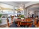 Bright dining room offers a round wood table, seating for six, and an outdoor view at 1386 Brayford Pt, Deland, FL 32724