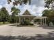 Community entry gate with charming architecture, decorative landscaping, and an American flag at 1386 Brayford Pt, Deland, FL 32724