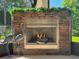 Covered lanai with full stone fireplace featuring glass enclosure and decorative metal heron sculptures at 1386 Brayford Pt, Deland, FL 32724