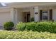 Inviting front porch with lush landscaping, pillars, outdoor seating, and decorative window shutters at 1386 Brayford Pt, Deland, FL 32724