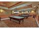 Features two billiard tables, warm lighting, and a cozy atmosphere, perfect for leisure and entertainment at 1386 Brayford Pt, Deland, FL 32724