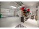Spacious garage with epoxy flooring, shelving, storage, and plenty of room for vehicles at 1386 Brayford Pt, Deland, FL 32724