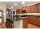 Spacious kitchen features granite counters, pendant lighting, stainless steel appliances and eat-in bar at 1386 Brayford Pt, Deland, FL 32724