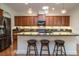 This kitchen features cherry cabinets, granite counters, decorative lighting, and stainless steel appliances at 1386 Brayford Pt, Deland, FL 32724