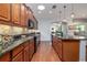 Gourmet kitchen features dark wood cabinetry, granite counters, stainless appliances, and a pass-through at 1386 Brayford Pt, Deland, FL 32724