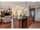 Open kitchen features stainless steel appliances, granite counters and breakfast bar overlooking the living area at 1386 Brayford Pt, Deland, FL 32724