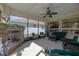 Enclosed lanai boasting a stone fireplace, ceiling fan, and an assortment of comfortable seating at 1386 Brayford Pt, Deland, FL 32724