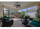 Inviting screened lanai features a stone fireplace, ceiling fan, and plenty of seating for relaxation at 1386 Brayford Pt, Deland, FL 32724