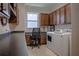 Functional laundry room with built-in cabinets, a desk area, and modern washer and dryer at 1386 Brayford Pt, Deland, FL 32724