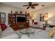 Cozy living room features plush seating, a ceiling fan, and a built-in entertainment center at 1386 Brayford Pt, Deland, FL 32724