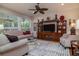 Comfortable living room features plush seating, a ceiling fan, and a built-in entertainment center at 1386 Brayford Pt, Deland, FL 32724