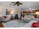 Open-concept living area featuring a kitchen bar, dining area, and comfortable seating with plenty of light at 1386 Brayford Pt, Deland, FL 32724