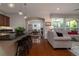 Open-concept living space featuring a kitchen bar, dining area, and comfortable seating area with large windows at 1386 Brayford Pt, Deland, FL 32724
