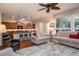 Open-concept space with kitchen, bar, dining area, comfortable seating, and hardwood floors at 1386 Brayford Pt, Deland, FL 32724