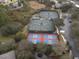 Aerial view of community tennis and pickleball courts with surrounding trees and parking at 1386 Brayford Pt, Deland, FL 32724
