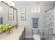 Bright bathroom featuring a large mirror, decorated art, and a decorative shower curtain at 1412 Bent Oaks Blvd, Deland, FL 32724