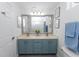 Bright bathroom with a double sink vanity, large mirror, and a view of the bathtub and shower at 1412 Bent Oaks Blvd, Deland, FL 32724