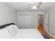 A comfortable bedroom with wood floors, a ceiling fan and a double closet at 1412 Bent Oaks Blvd, Deland, FL 32724