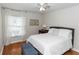 Inviting bedroom featuring a plush queen-sized bed, hardwood floors and bright natural light at 1412 Bent Oaks Blvd, Deland, FL 32724