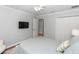 Simple bedroom is cozy and carpet free and contains a fan, tv, closet and plenty of natural light at 1412 Bent Oaks Blvd, Deland, FL 32724