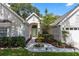 Inviting home entrance with a tiled walkway, a light green door, and lush landscaping at 1412 Bent Oaks Blvd, Deland, FL 32724