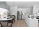 Open kitchen with stainless steel appliances, white cabinets and tile floors at 1412 Bent Oaks Blvd, Deland, FL 32724