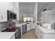 Bright kitchen features white cabinets, stainless steel appliances, and a decorative backsplash at 1412 Bent Oaks Blvd, Deland, FL 32724