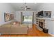 Bright living room features a ceiling fan, fireplace and sliding glass doors to the lanai at 1412 Bent Oaks Blvd, Deland, FL 32724