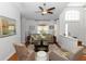 Cozy living room featuring a ceiling fan, two chairs and hardwood floors at 1412 Bent Oaks Blvd, Deland, FL 32724