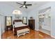 A spacious main bedroom has wood floors, a ceiling fan, and access to the main bathroom at 1412 Bent Oaks Blvd, Deland, FL 32724