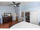 A spacious main bedroom has wood floors, a ceiling fan, and a walk-in closet at 1412 Bent Oaks Blvd, Deland, FL 32724