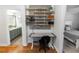 A cozy desk sits between the bedroom and a well-appointed bathroom at 1412 Bent Oaks Blvd, Deland, FL 32724
