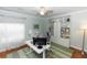 Well-lit home office featuring a modern desk, built-in shelving, and ample workspace at 1412 Bent Oaks Blvd, Deland, FL 32724