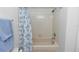 Bathroom with shower, floral curtain and tiled walls at 1412 Bent Oaks Blvd, Deland, FL 32724