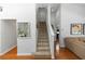 Bright stairway with a carpet runner and white handrail leads to the upper level at 1412 Bent Oaks Blvd, Deland, FL 32724