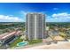 Stunning aerial view of oceanfront condo tower with pool and beach access under sunny sky at 1420 N Atlantic Ave # 202, Daytona Beach, FL 32118