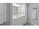 Clean bathroom with vanity, storage cabinet, large mirror, and neutral wall color at 1420 N Atlantic Ave # 202, Daytona Beach, FL 32118