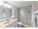 Well-lit bathroom features a glass shower, a modern vanity and fixtures at 1420 N Atlantic Ave # 202, Daytona Beach, FL 32118