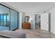 Bedroom features a dresser and sliding glass doors to the balcony with ocean views at 1420 N Atlantic Ave # 202, Daytona Beach, FL 32118